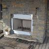 outside fireplace out of fieldstone to enjoy on there deck.The hearth is also one solid rock.